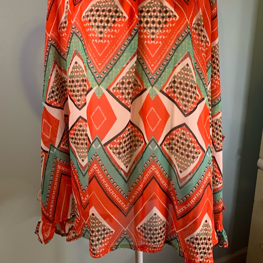 Patterned shirt. Multi color Poncho style shirt.